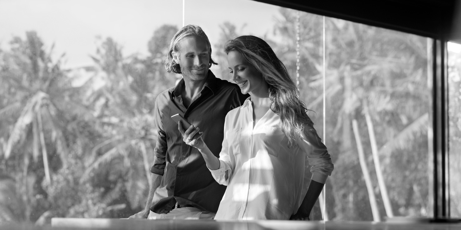 Smiling couple discussing their residential lending options