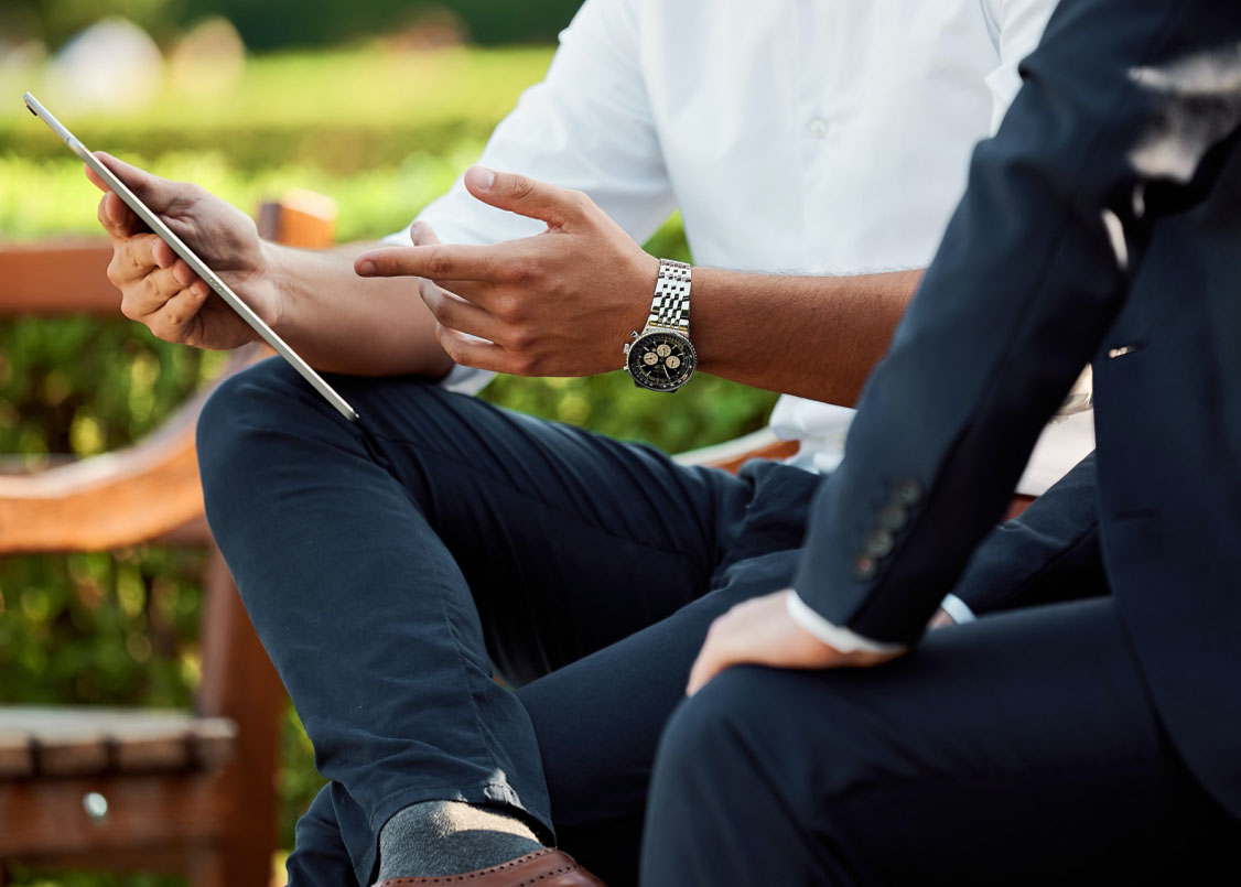 Person holding a tablet reviewing their finances